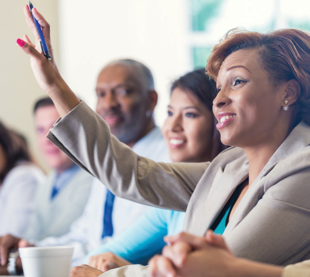 Person raising hand in meeting