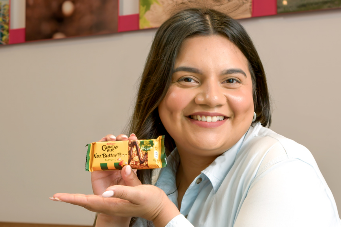 Woman holding up granola bar